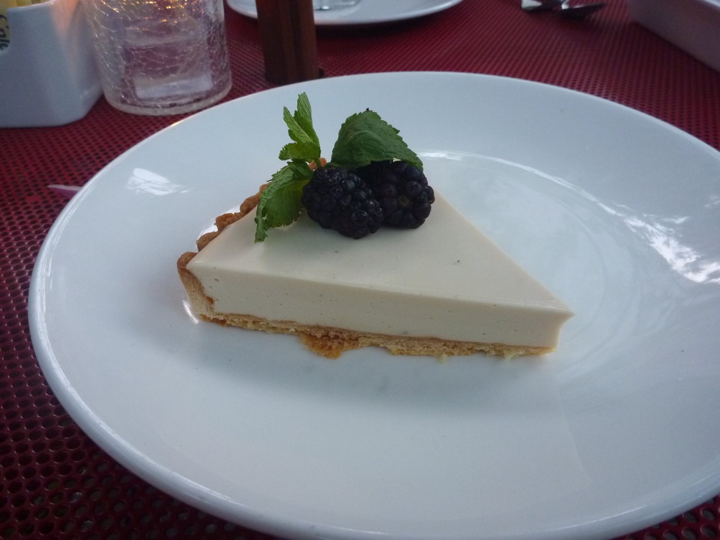 Earl Grey tart on Chez Piggy's red courtyard patio table